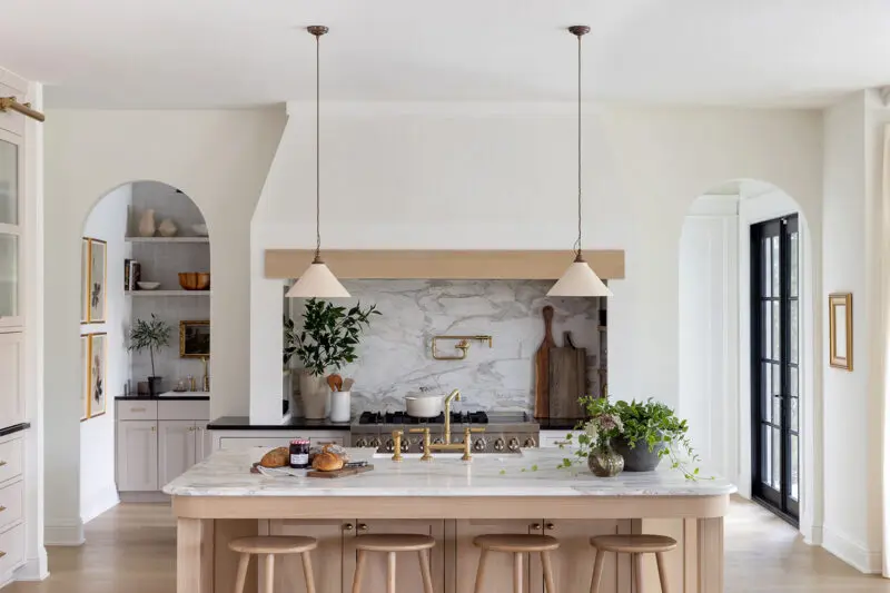 A kitchen in a residential home decorated in neutral colors.