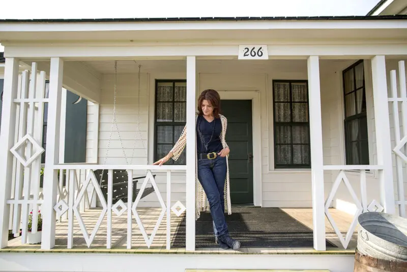 Rosanne Cash stands on the front porch of her dad Johnny Cash's boyhood home.