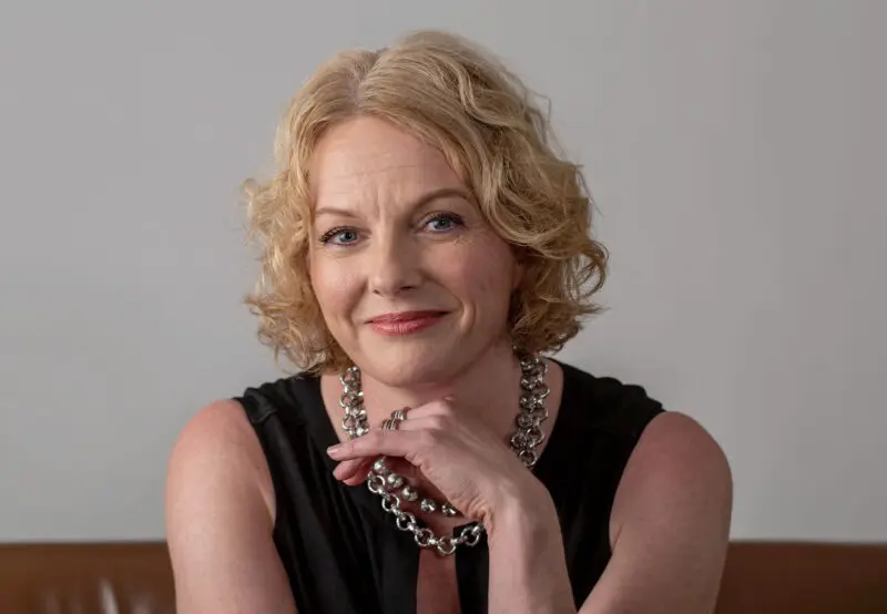 portrait of an executive sitting on a couch against a plain background