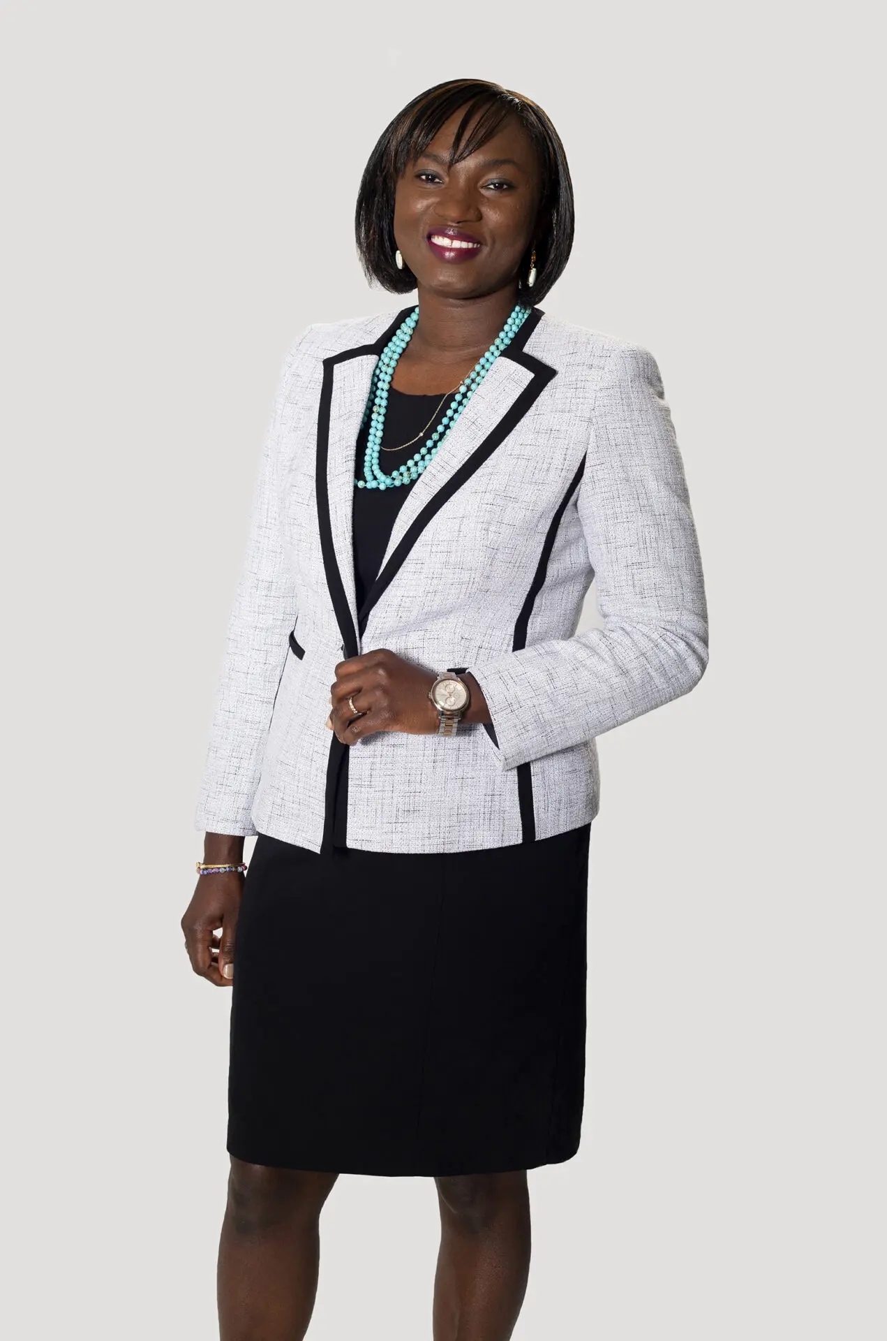 portrait of a Black woman taken in a photography studio on a white background.
