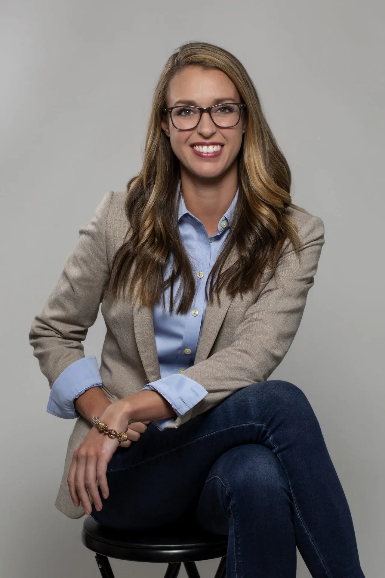 head shot of a woman taken in a photography studio on a light background.