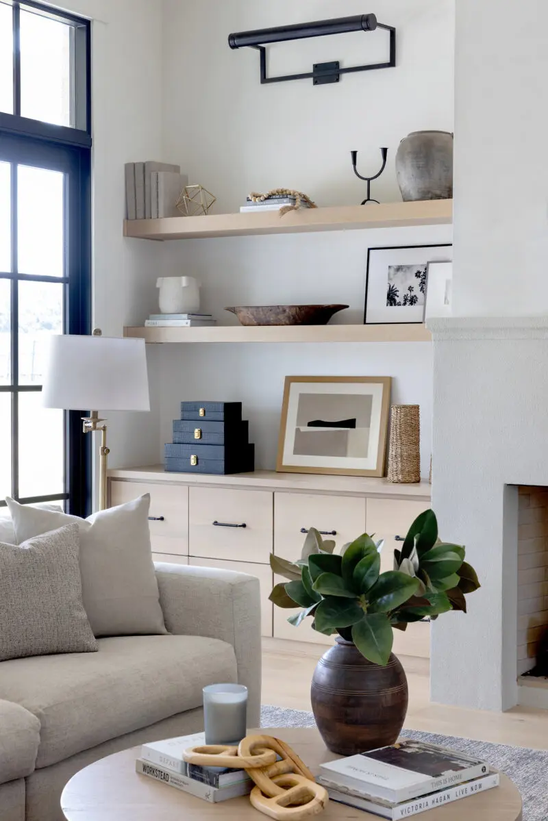 Detail of a bookshelf with photos and a stack of boxes.