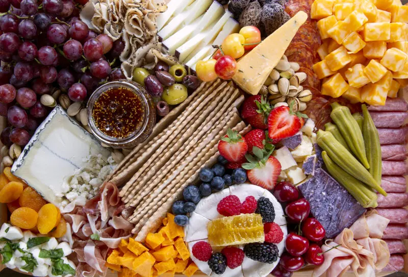Food photography of a charcuterie board with crackers, honey and cheese taken for a magazine feature.