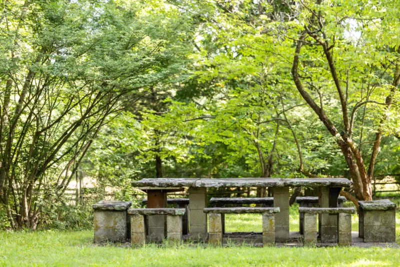 Professional architecture photography in Fayetteville, Arkansas, capturing the exterior picnic bench of the Sutherland family home.