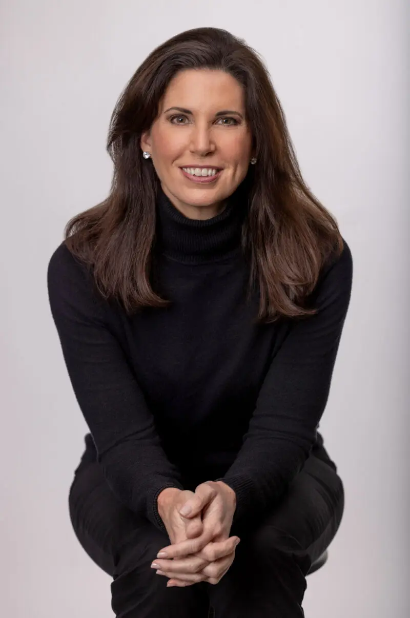 Branding portrait of a woman in a black turtleneck seated in a studio, photographed in Fayetteville, Arkansas by Beth Hall Photography.