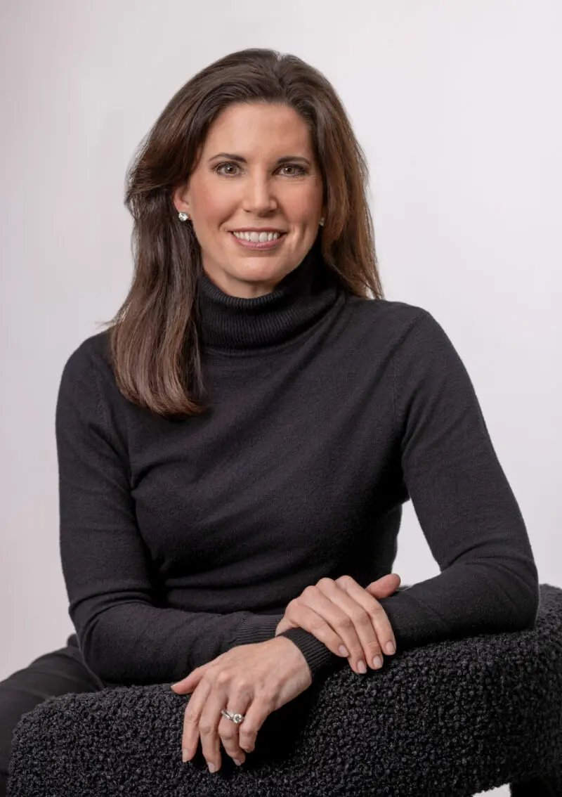 Branding portrait of a woman in a black turtleneck seated in a studio, photographed in Fayetteville, Arkansas by Beth Hall Photography.