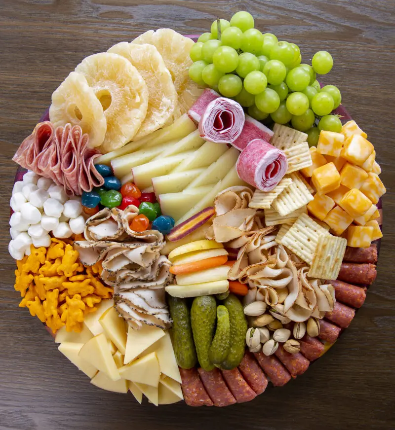 Food photography of a charcuterie board with crackers, honey and cheese taken for a magazine feature.