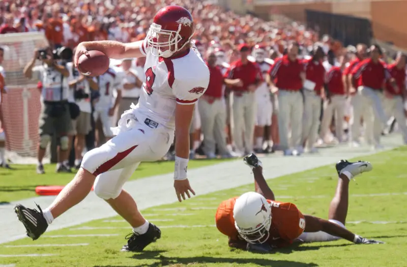 Unaltered Image of Arkansas Quarterback Matt Jones scoring a touchdown during a game against Texas with Horns down.
