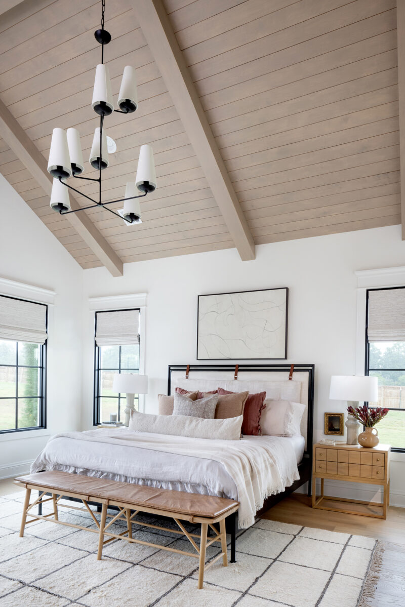 Interior photography of a primary bedroom designed in neutral colors.