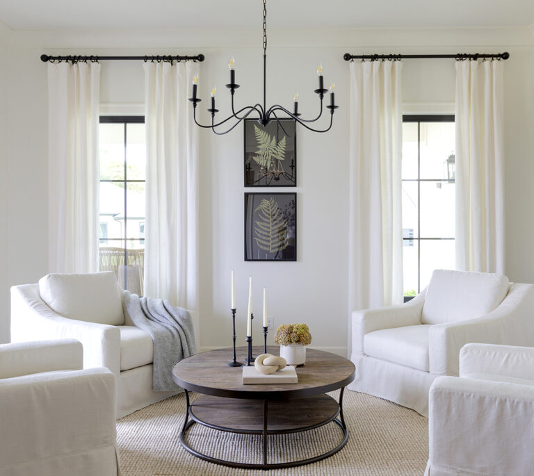 Interior Photographer of a living room with white curtains, white chairs and white carpet.