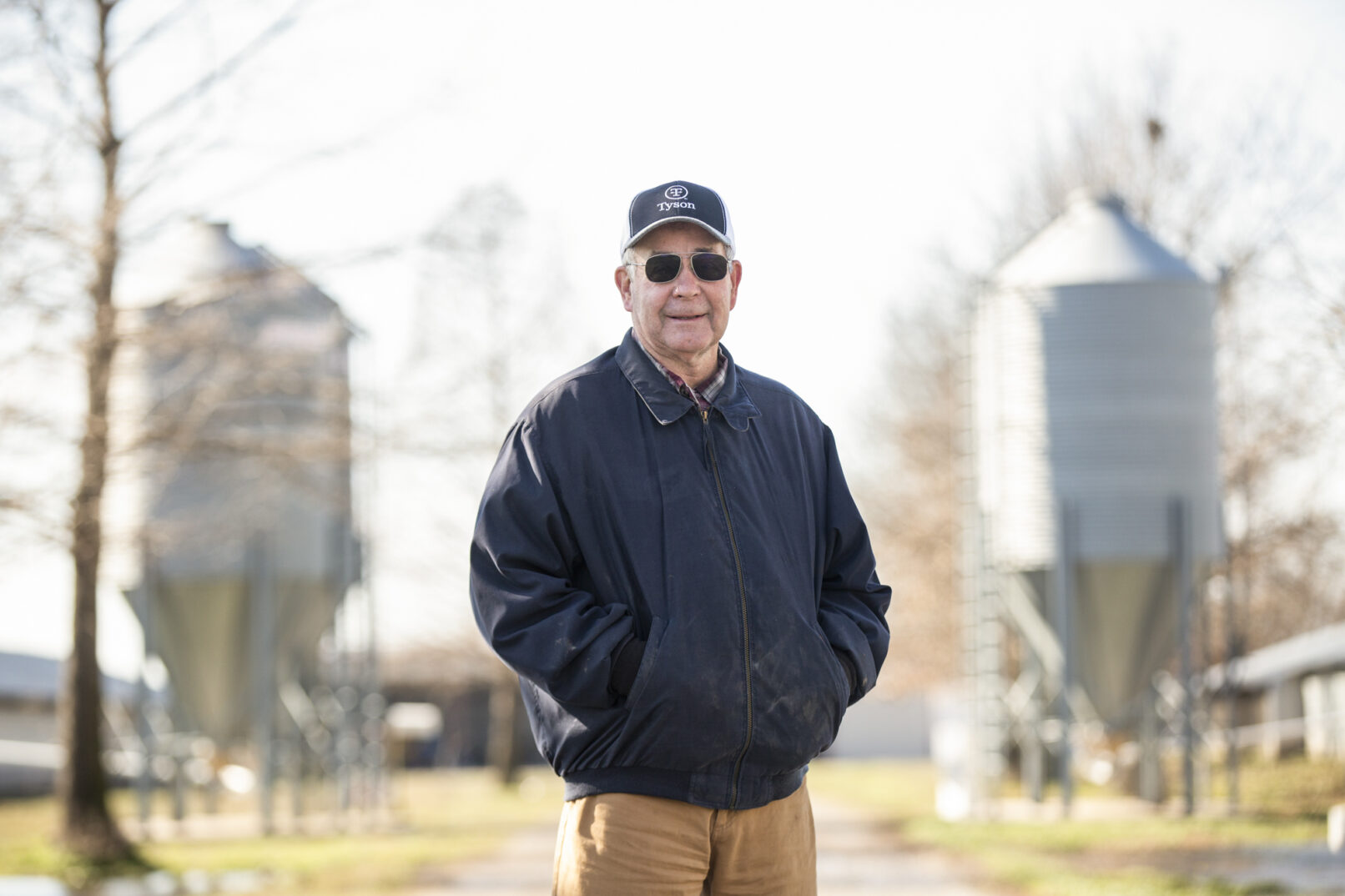 Environmental portrait of a chicken farmer standing on his farm in Missouri