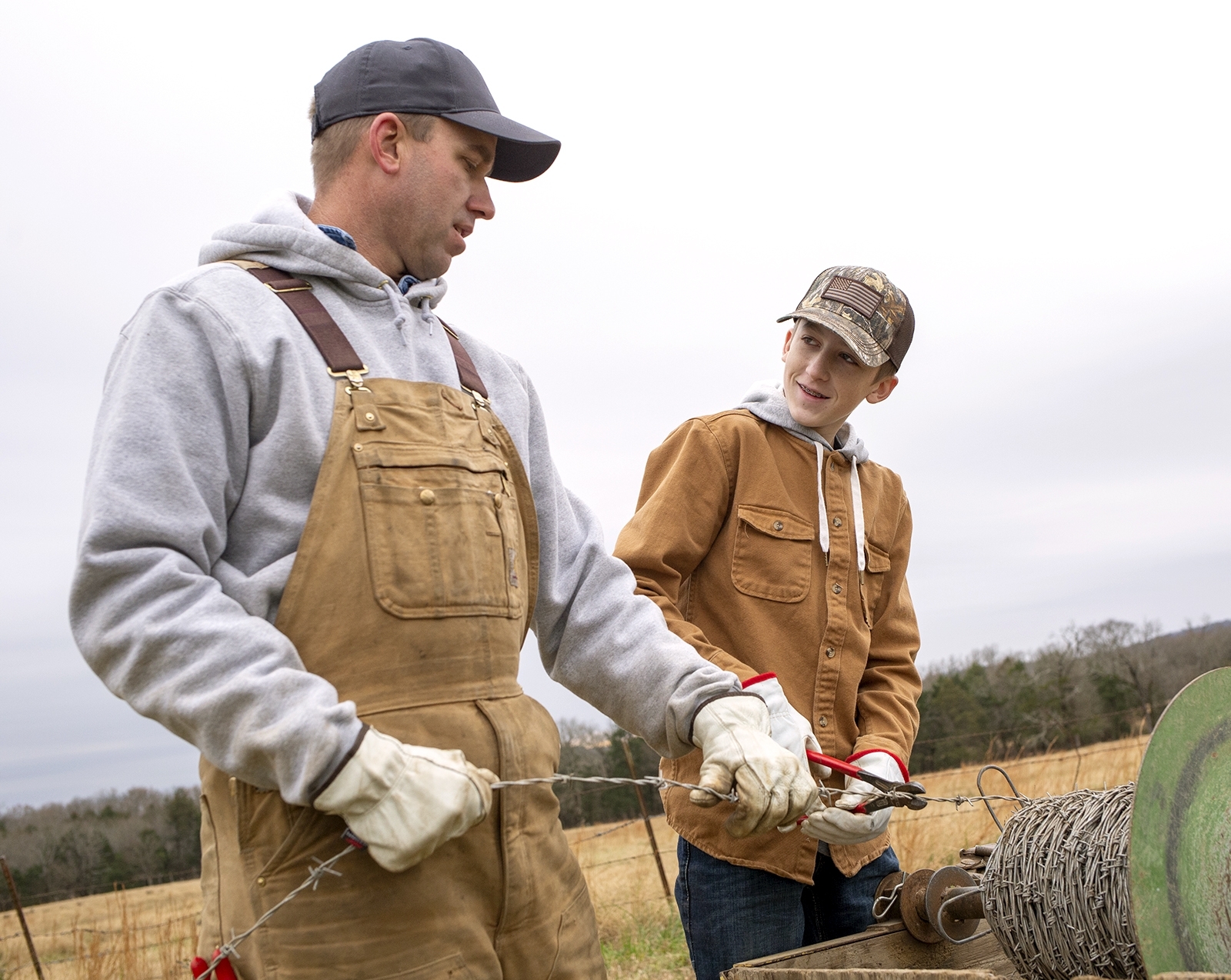 A father and son work together to fix a fence in Fort Smith, Arkansas.