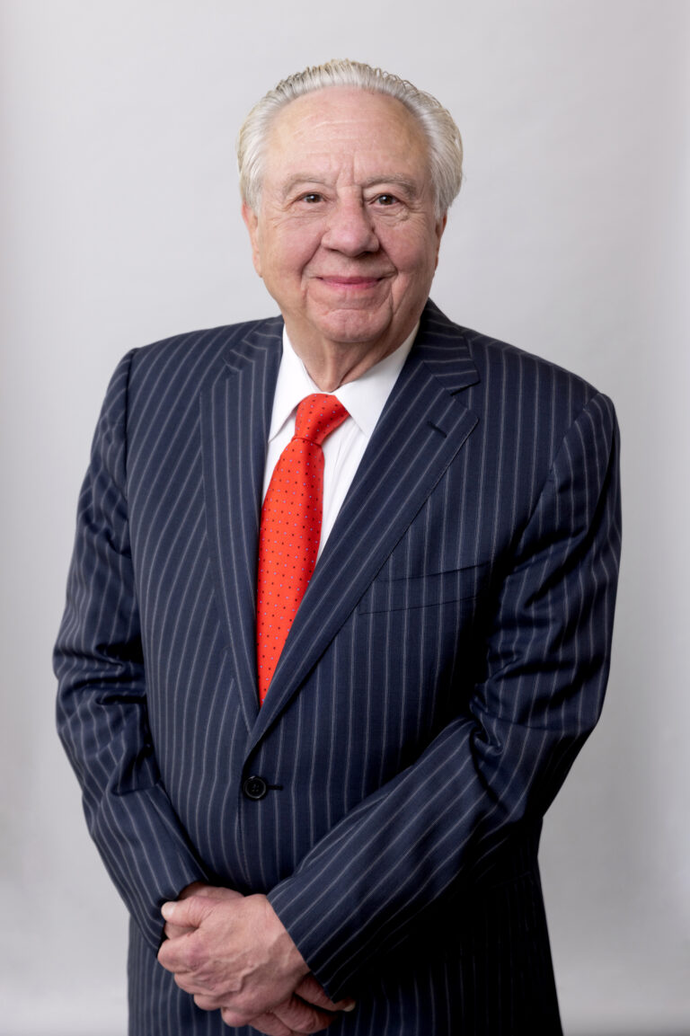 Studio headshot of a white man on a white background using professional lighting.