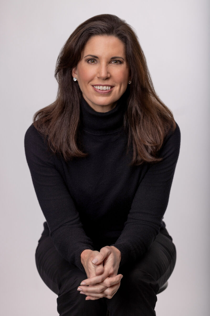 Branding portrait of a woman in a black turtleneck seated in a studio, photographed in Fayetteville, Arkansas by Beth Hall Photography.