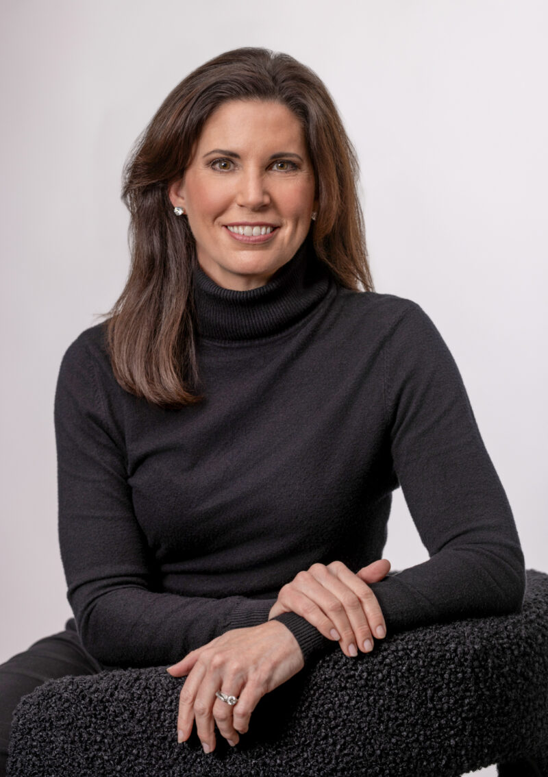 Branding portrait of a woman in a black turtleneck seated in a studio, photographed in Fayetteville, Arkansas by Beth Hall Photography.