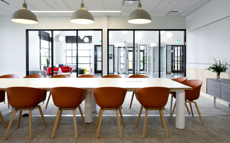 Interior photo of a conference room with orange chairs.