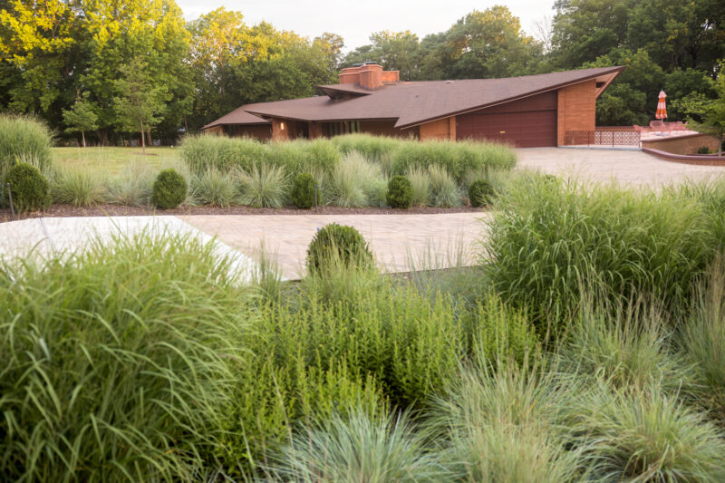 Photo of the exterior of a red brick home designed by E Fay Jones in Fayetteville, Arkansas.