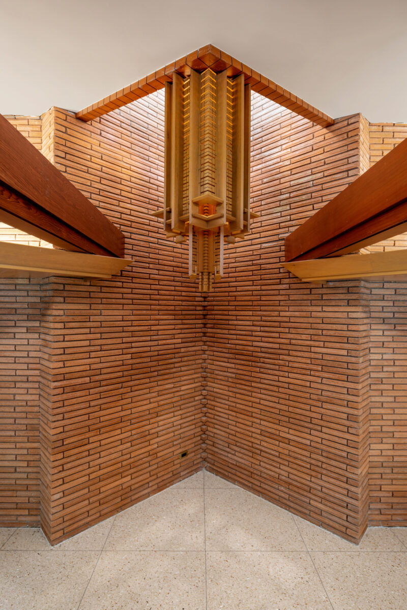 Interior photography of the entrance of a home with red bricks designed by E Fay Jones.