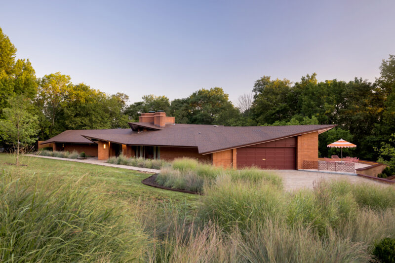 Photo of the exterior of a red brick home designed by E Fay Jones in Fayetteville, Arkansas.