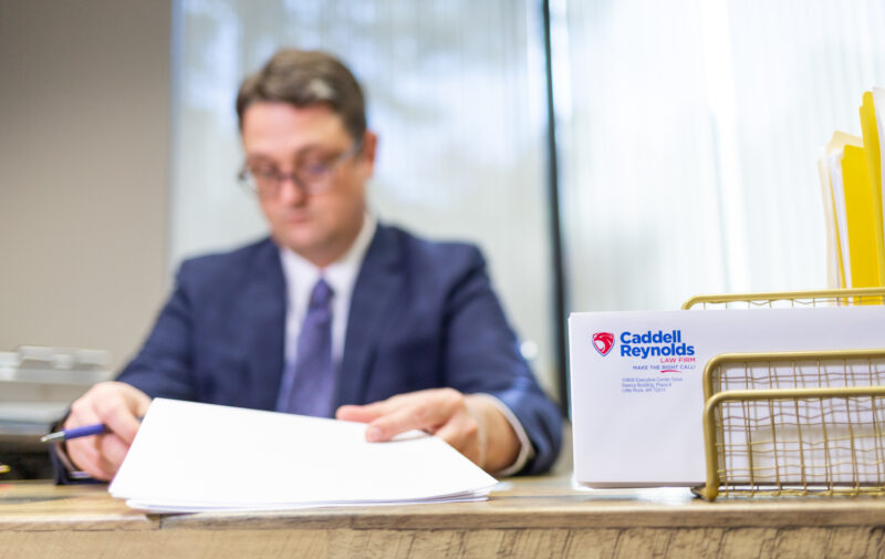 Portrait of an attorney working while sitting at a desk.