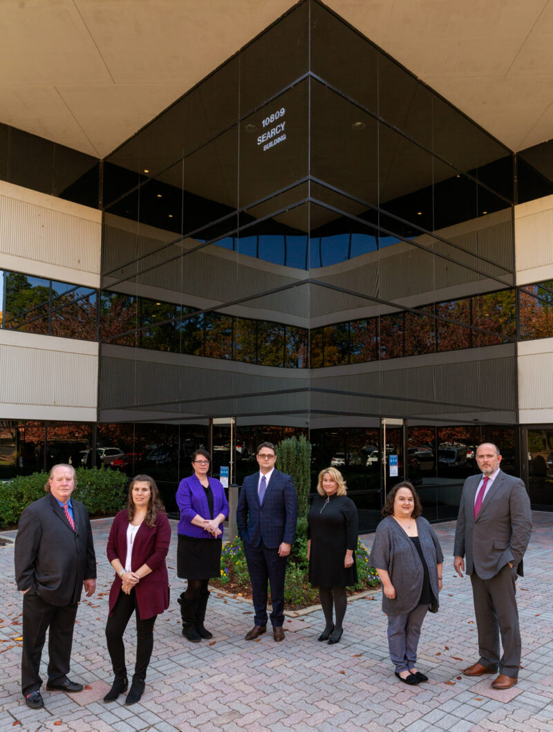 Group portrait of attorneys standing in front of a building in Little Rock, Arkansas.