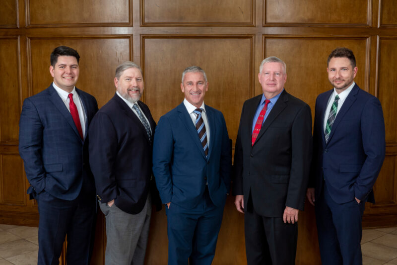 Group portrait of attorneysin the entrance of a building.