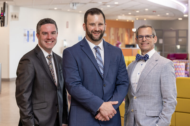 Group photo of executives standing outside of Arkansas Children's Hospital taken by Northwest Arkansas commercial photographer Beth Hall.
