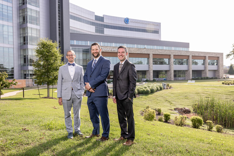 Group photo of executives standing outside of Arkansas Children's Hospital taken by Northwest Arkansas commercial photographer Beth Hall.