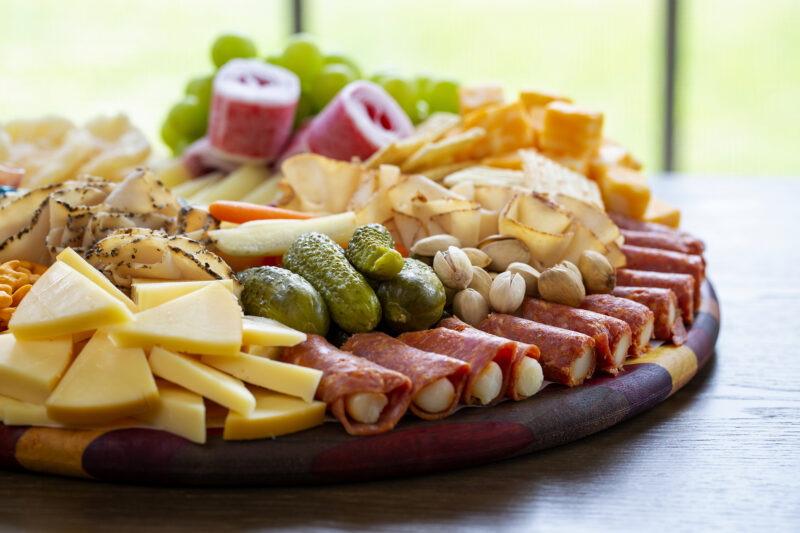 Food photography of a charcuterie board with crackers, honey and cheese taken for a magazine feature.