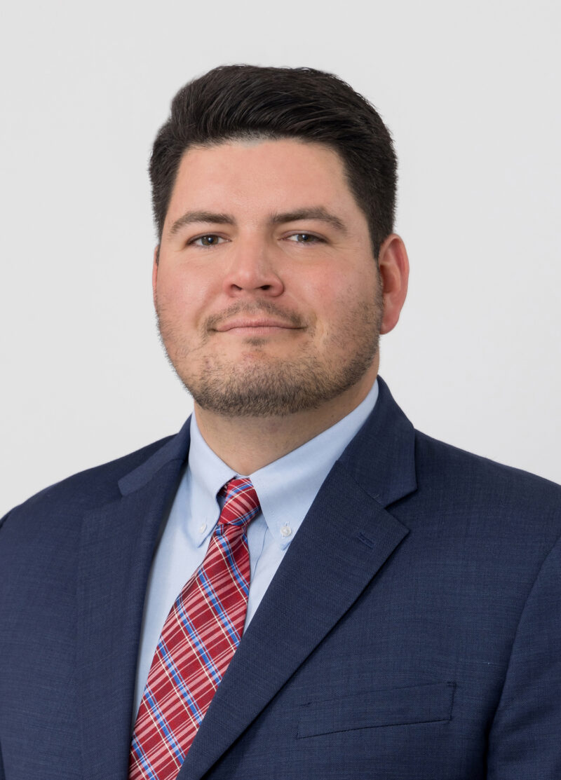 Head shot of an attorney on a white backdrop.