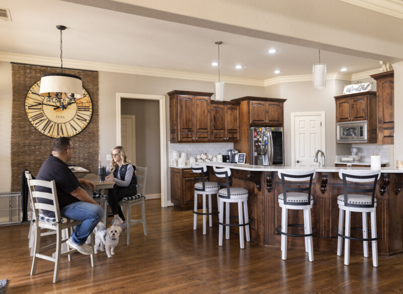 Interior of a kitchen and dining room with people sitting at a table in Rogers, Ark.