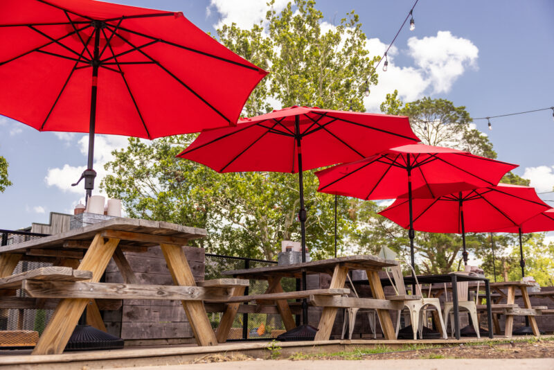 Photo of picnic tables and red umbrella outside of Wrights BBQ in Bentonville, Arkansas.